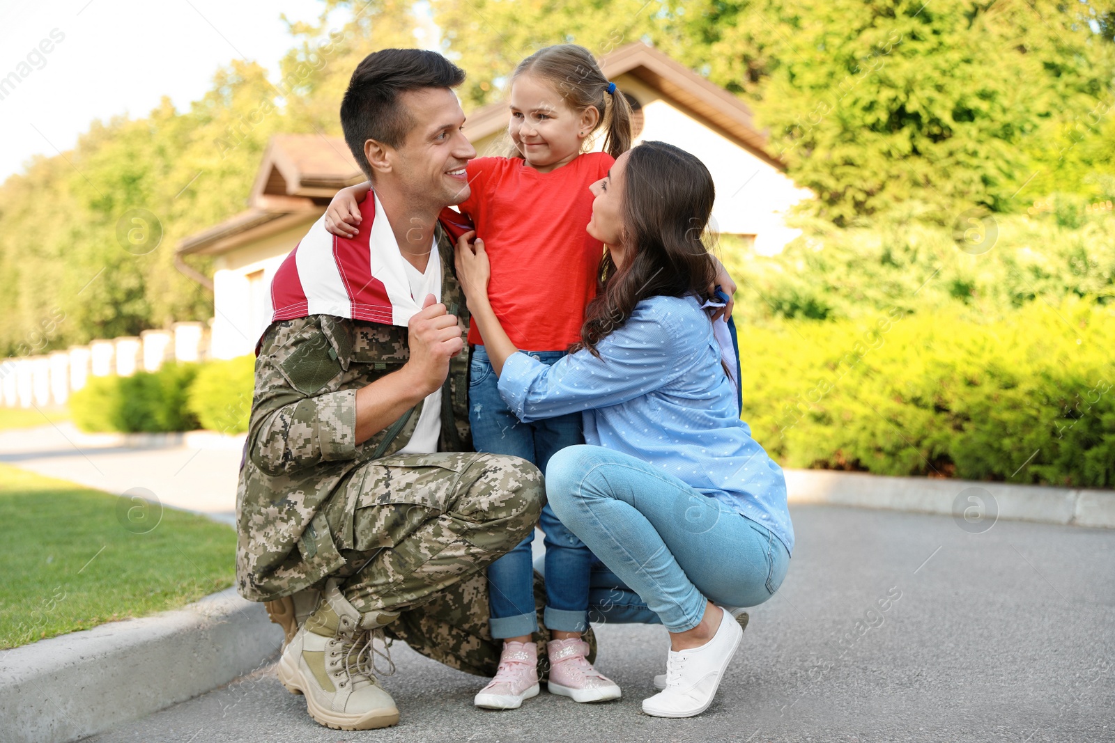 Photo of Man in military uniform and his family outdoors