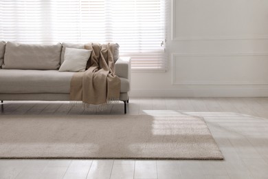 Photo of Stylish soft carpet on floor in living room, space for text