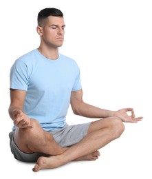 Handsome man meditating on white background. Harmony and zen