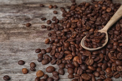 Spoon and coffee beans on wooden table