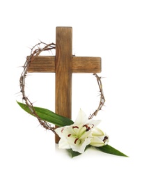 Photo of Wooden cross, crown of thorns and blossom lilies on white background