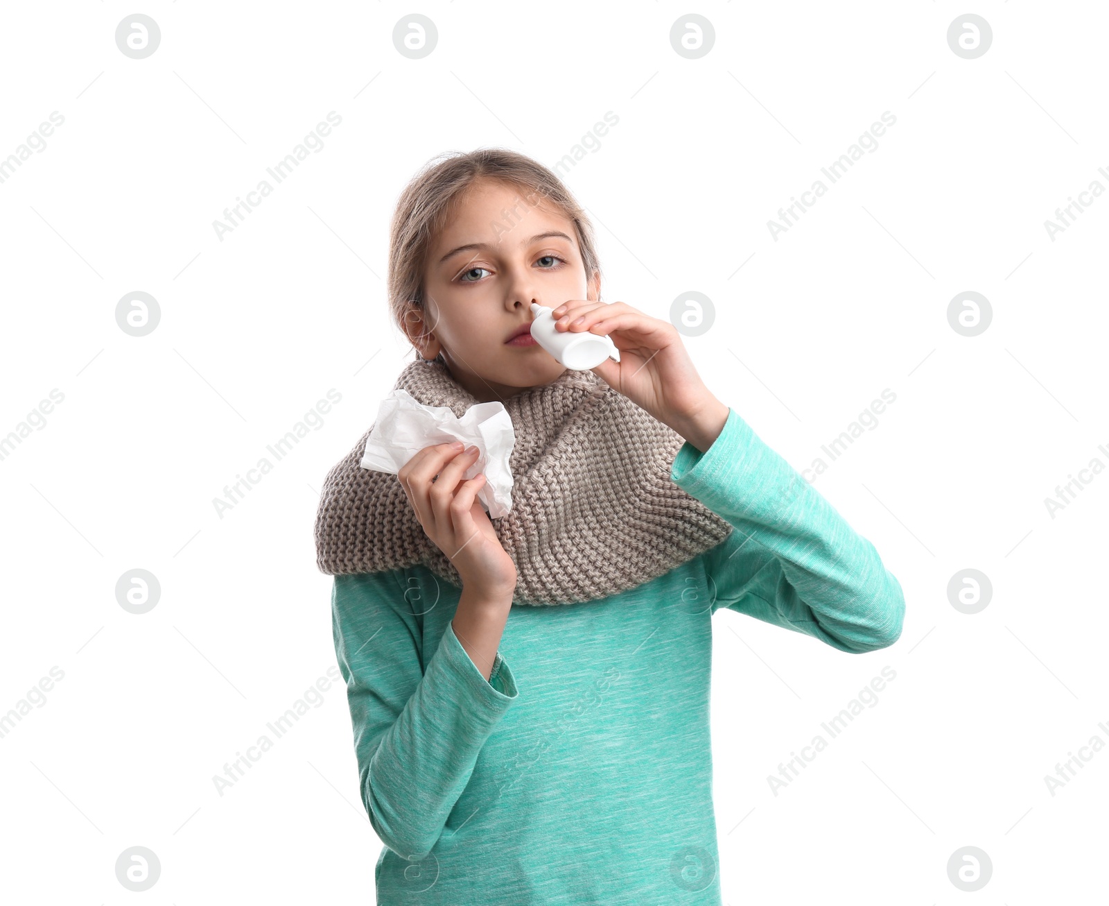 Photo of Sick little girl using nasal spray on white background