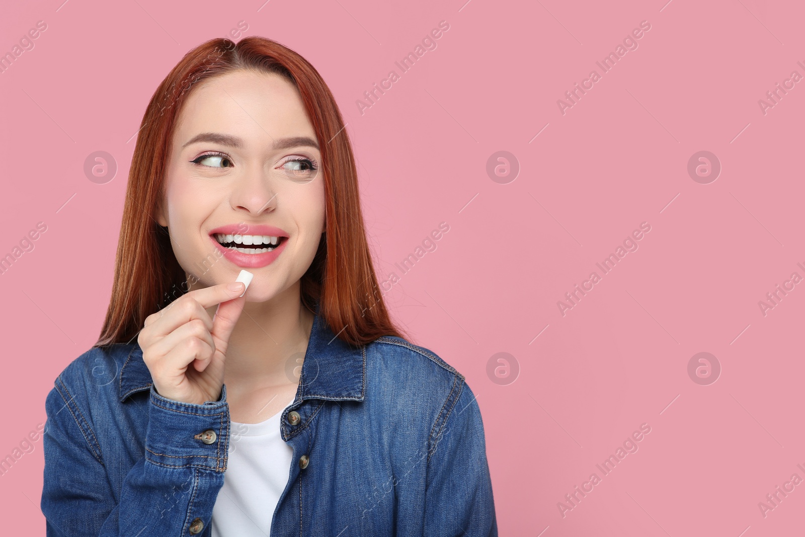 Photo of Beautiful woman with bubble gum on pink background, space for text