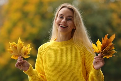 Photo of Portrait of happy woman with autumn leaves outdoors