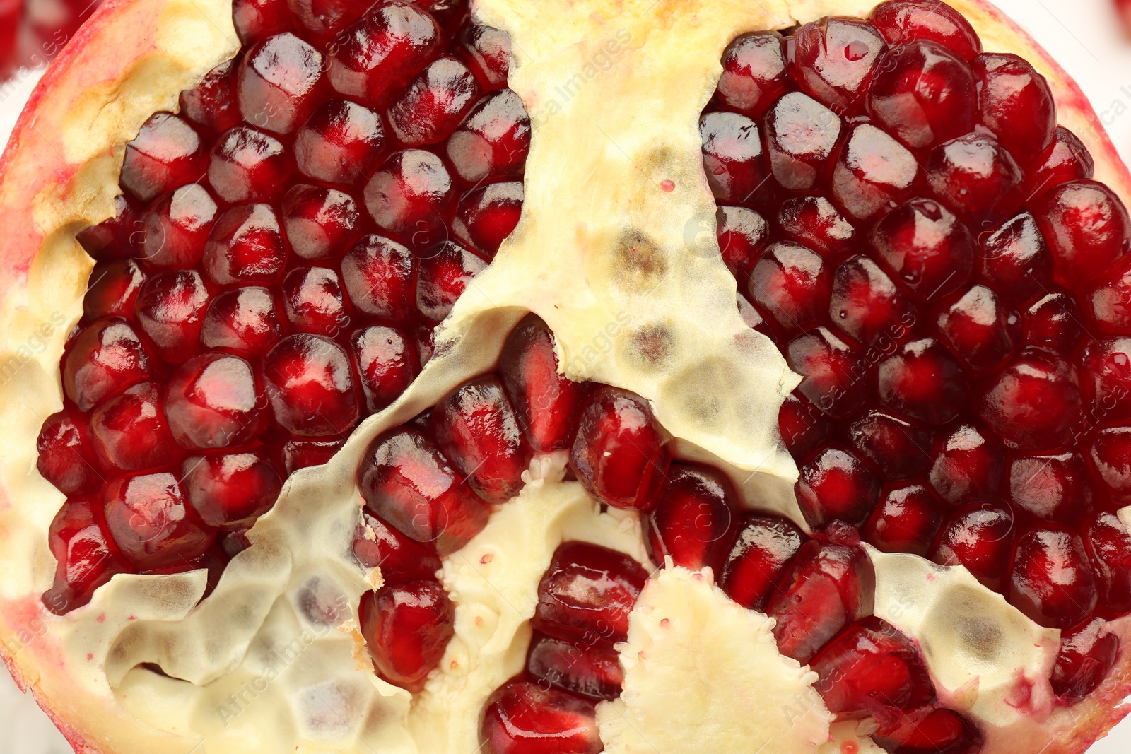 Photo of Ripe juicy pomegranate grains as background, closeup