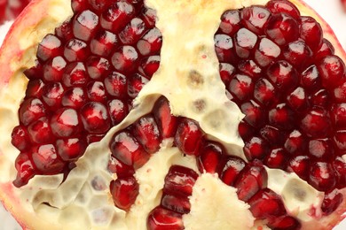 Photo of Ripe juicy pomegranate grains as background, closeup