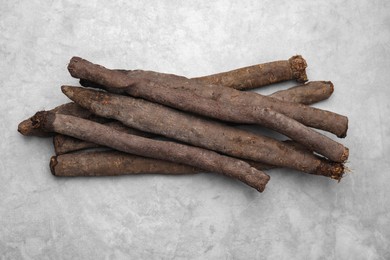 Photo of Raw salsify roots on grey table, flat lay