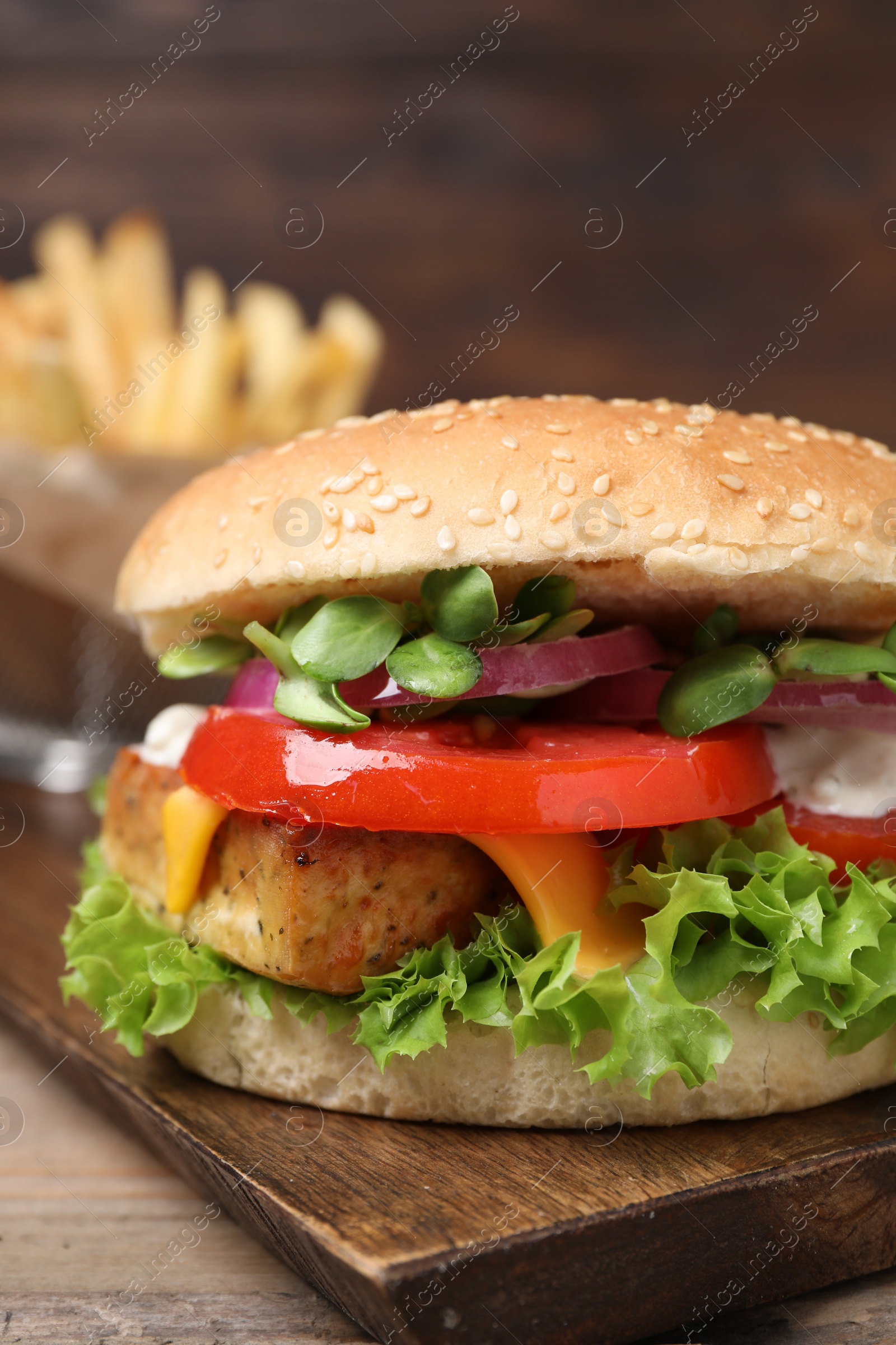 Photo of Delicious burger with tofu and fresh vegetables on table, closeup