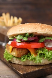 Photo of Delicious burger with tofu and fresh vegetables on table, closeup