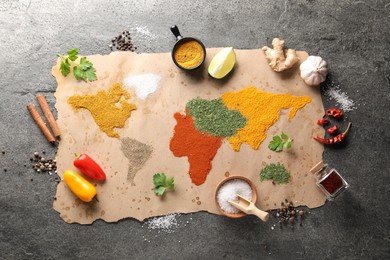 World map of different spices and products on grey table, top view