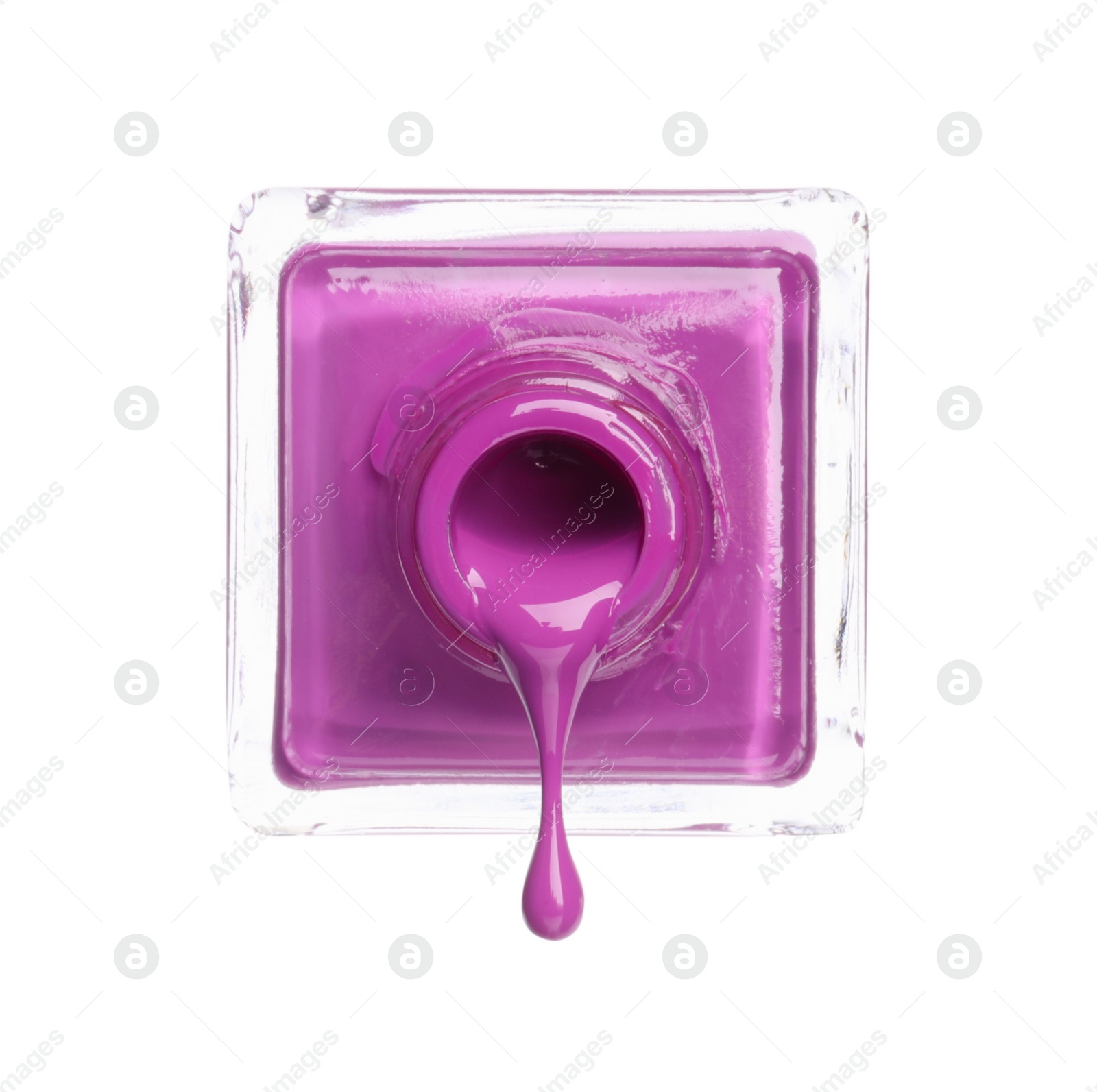 Photo of Violet nail polish dripping from bottle isolated on white