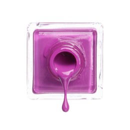Photo of Violet nail polish dripping from bottle isolated on white