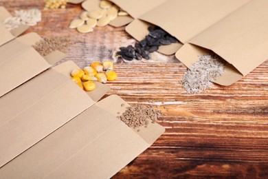 Photo of Many different vegetable seeds on wooden table