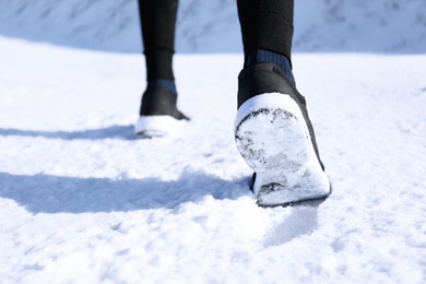 Man running outdoors on winter day, closeup. Sports exercises