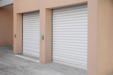 Photo of Building with white roller shutter garage doors