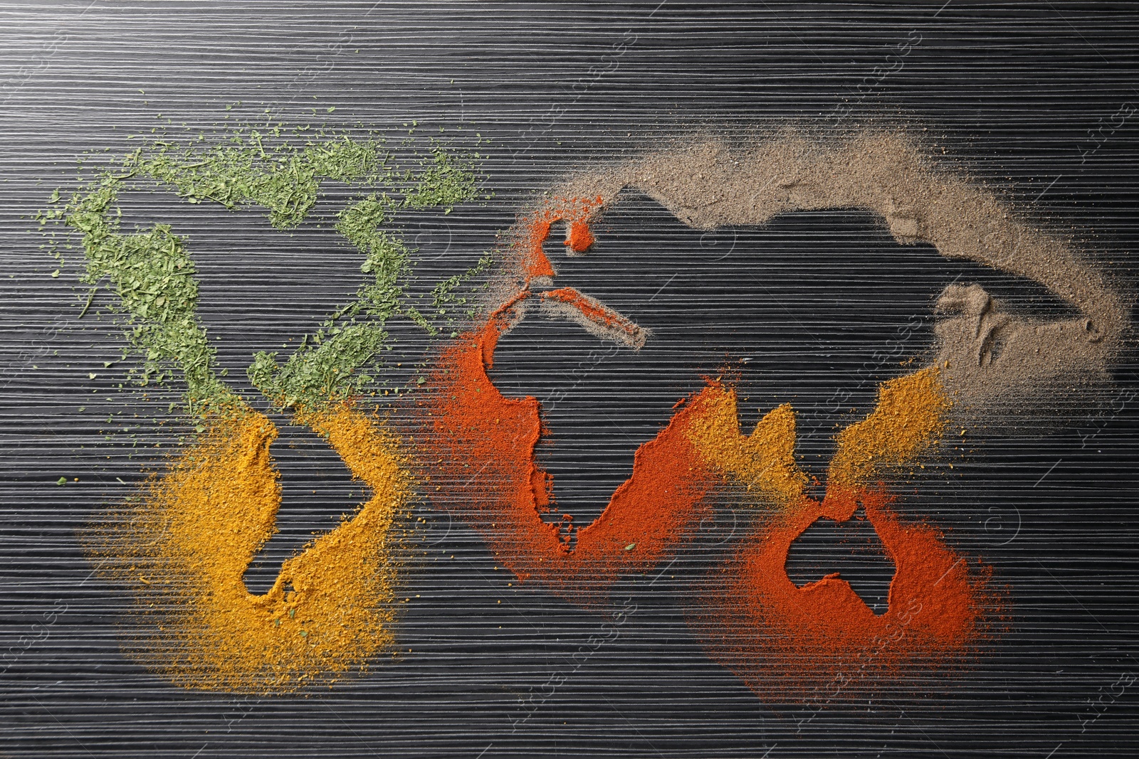 Photo of World map of different spices on black wooden table, flat lay