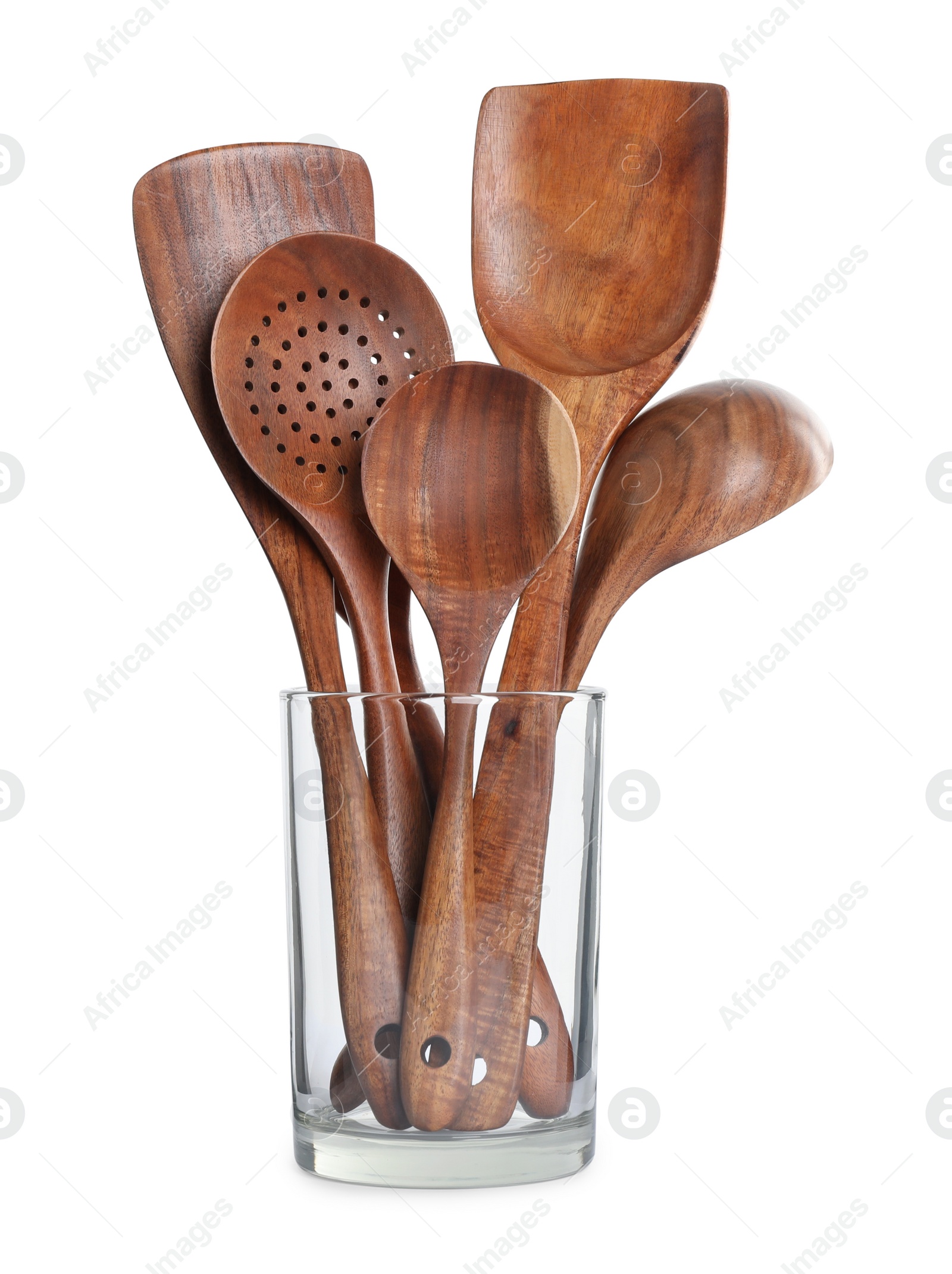 Photo of Set of wooden kitchen utensils in glass holder isolated on white