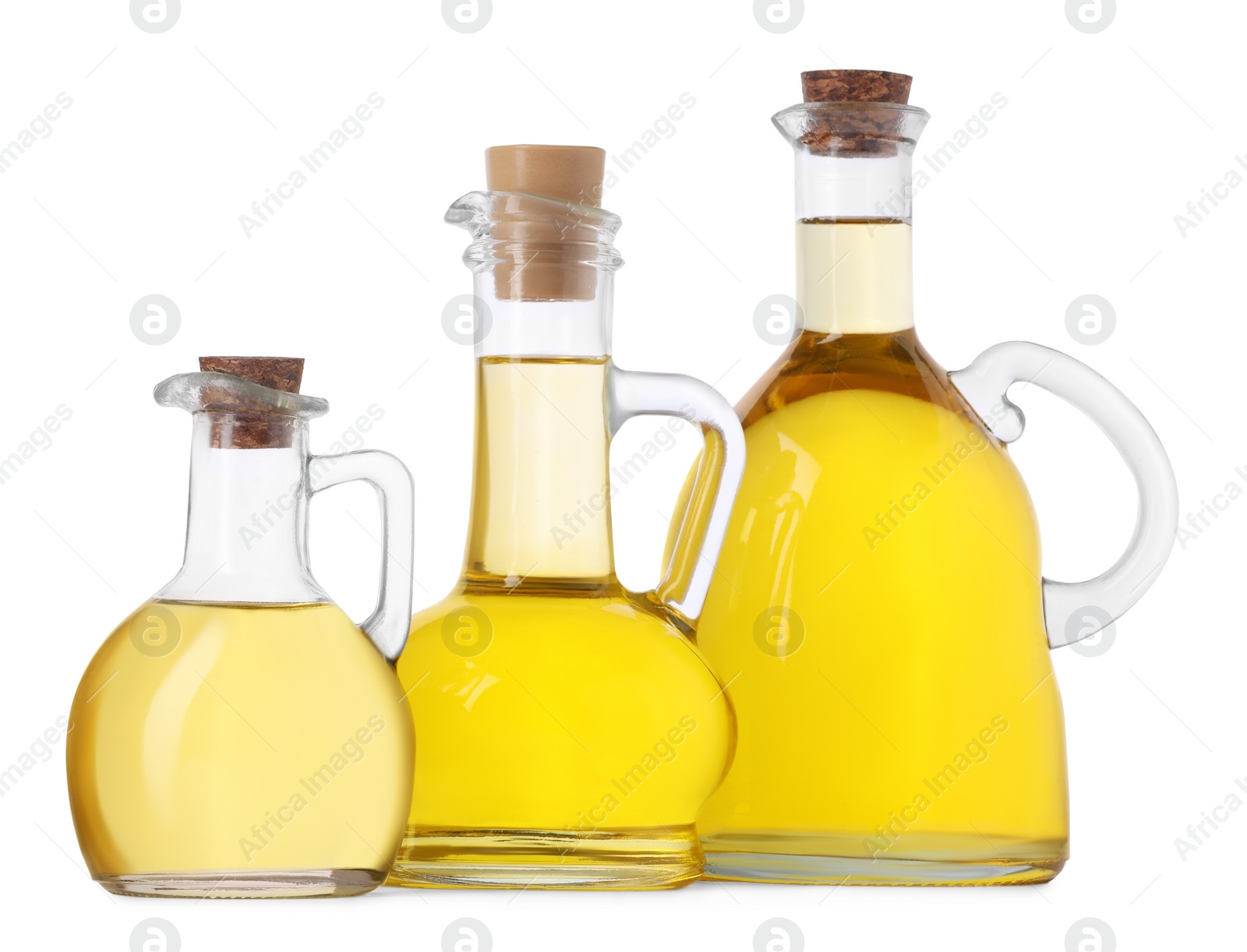 Photo of Glass jugs of cooking oil on white background