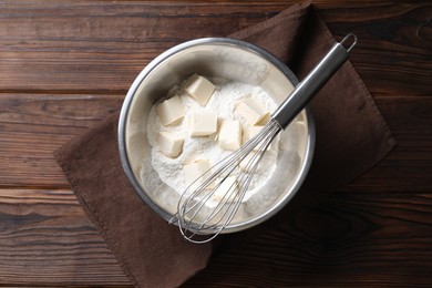 Making shortcrust pastry. Flour, butter and whisk on wooden table, top view