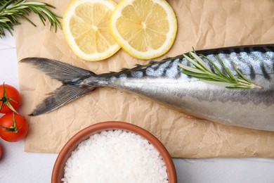 Photo of Tasty raw mackerel and ingredients on white textured table, flat lay