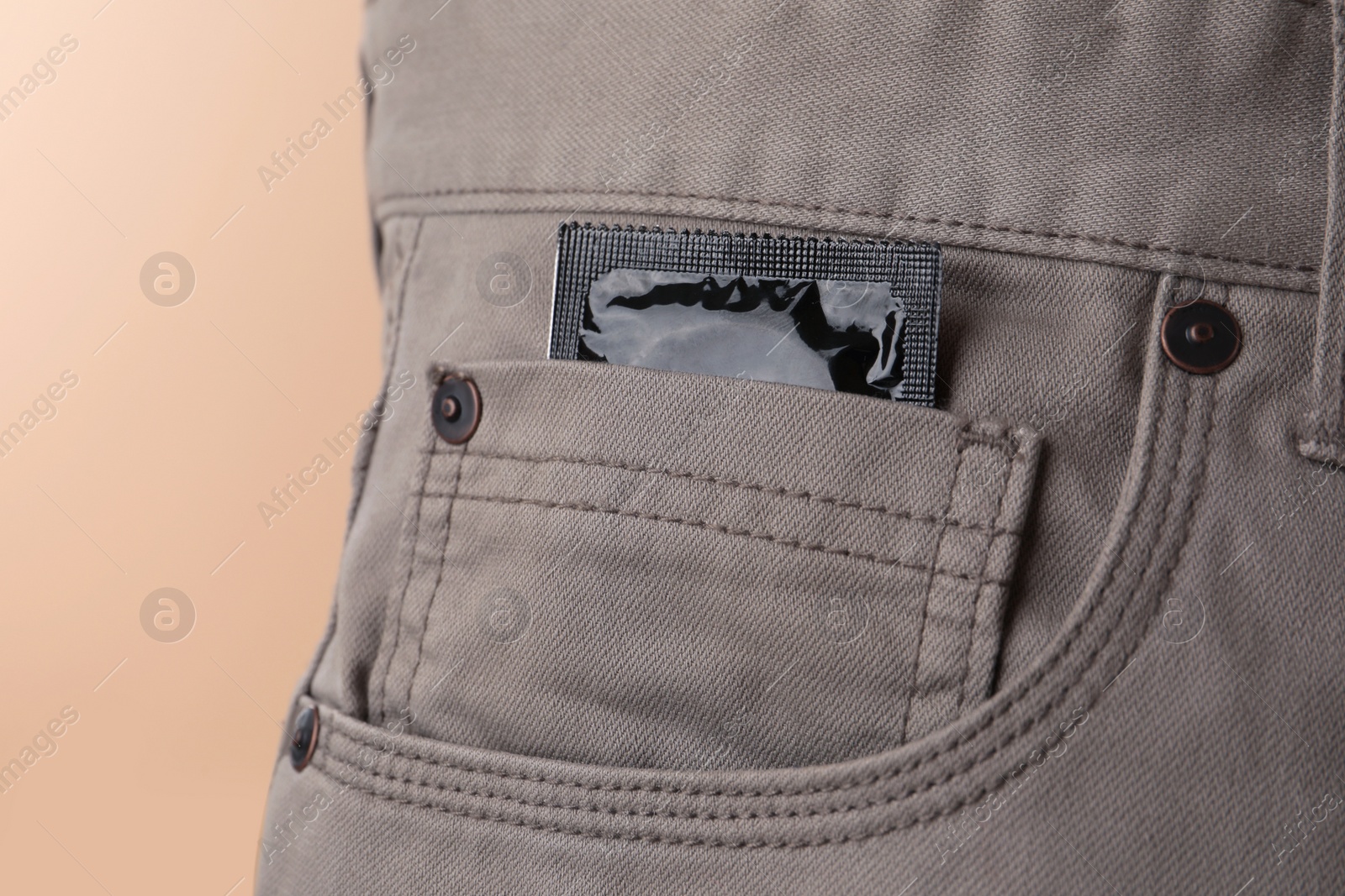 Photo of Pants with condom in pocket, closeup. Potency problem