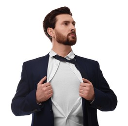 Confident businessman wearing superhero costume under suit on white background