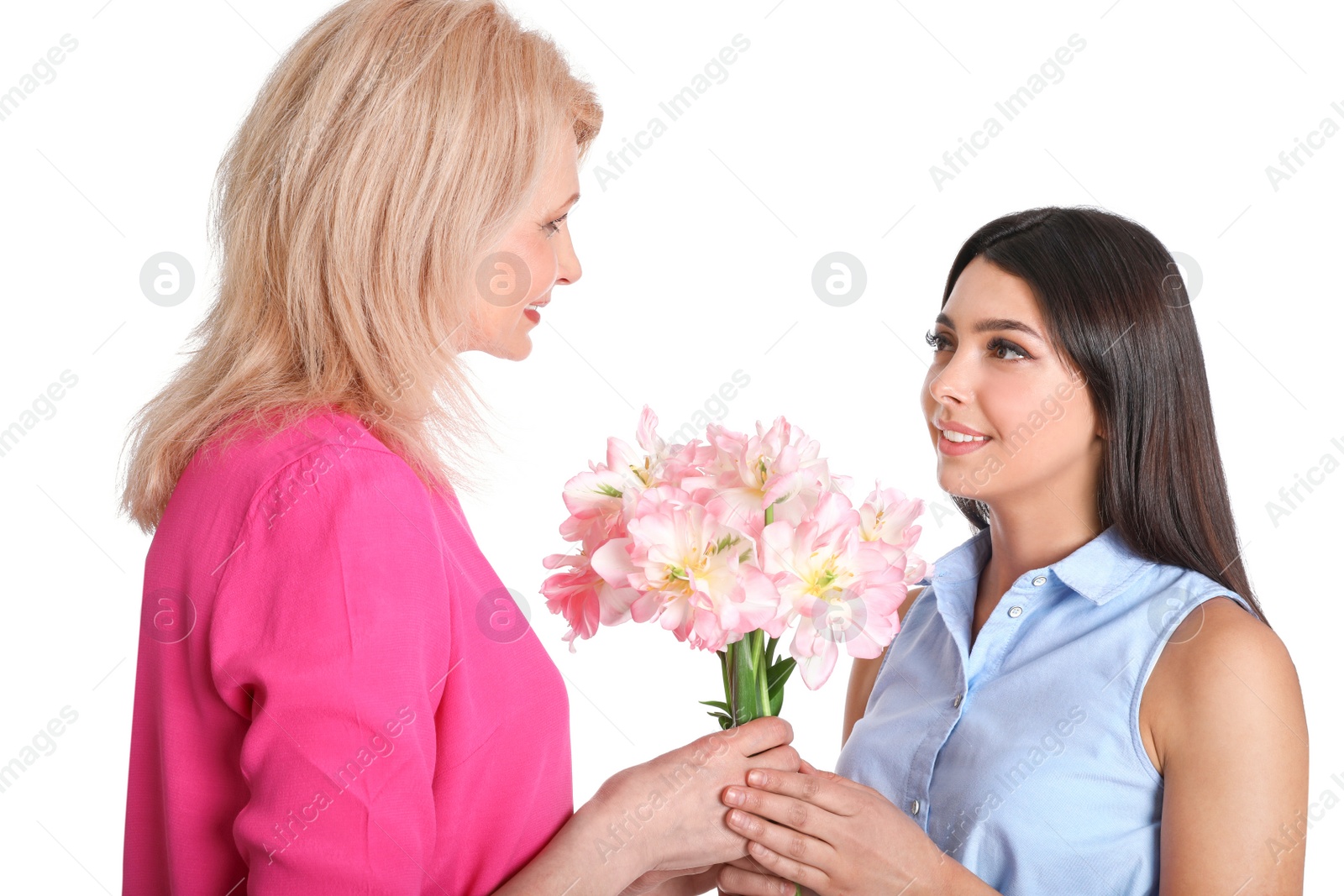 Photo of Young woman congratulating her mature mom on white background. Happy Mother's Day