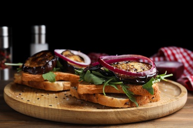 Photo of Delicious fresh eggplant sandwiches served on wooden table