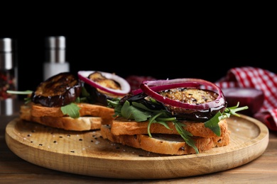 Delicious fresh eggplant sandwiches served on wooden table