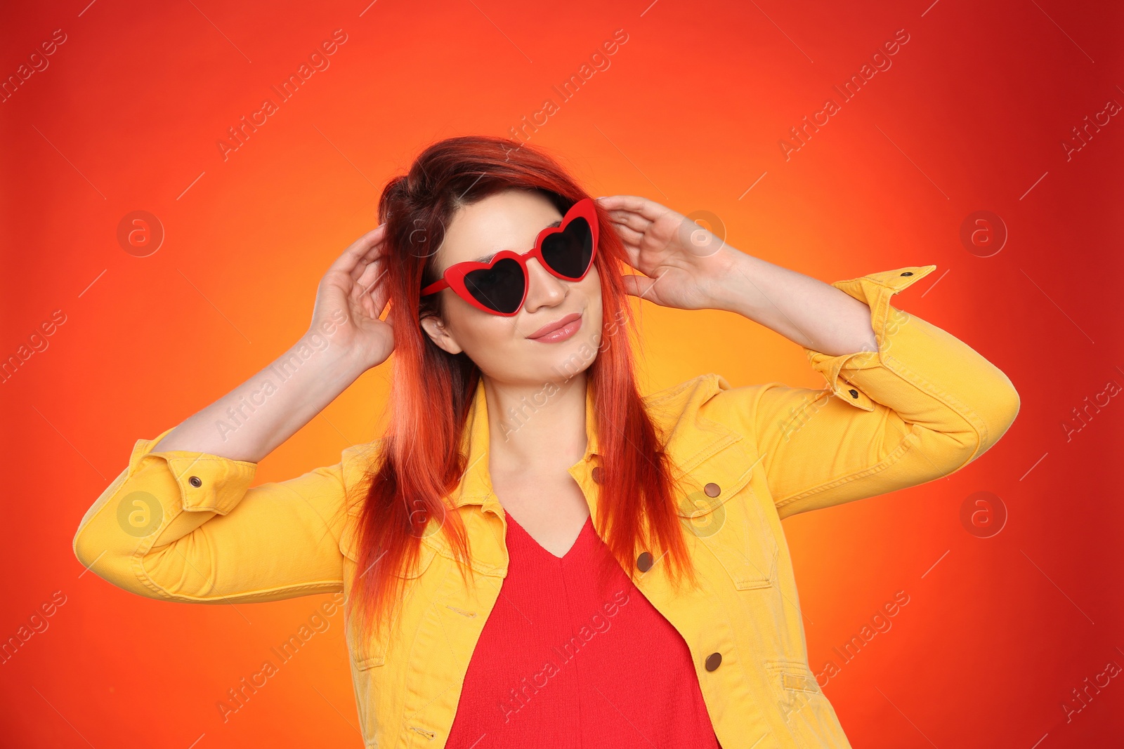 Photo of Young woman with bright dyed hair on color background