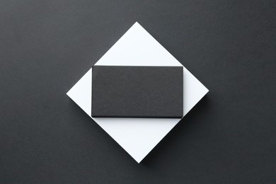 Photo of Blank business card on black background, top view. Mockup for design