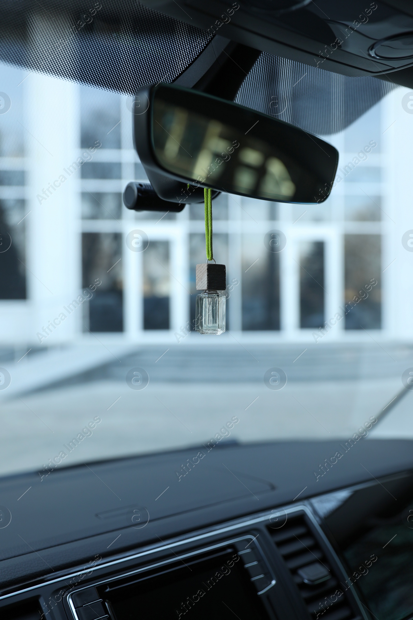 Photo of Air freshener hanging on rear view mirror in car