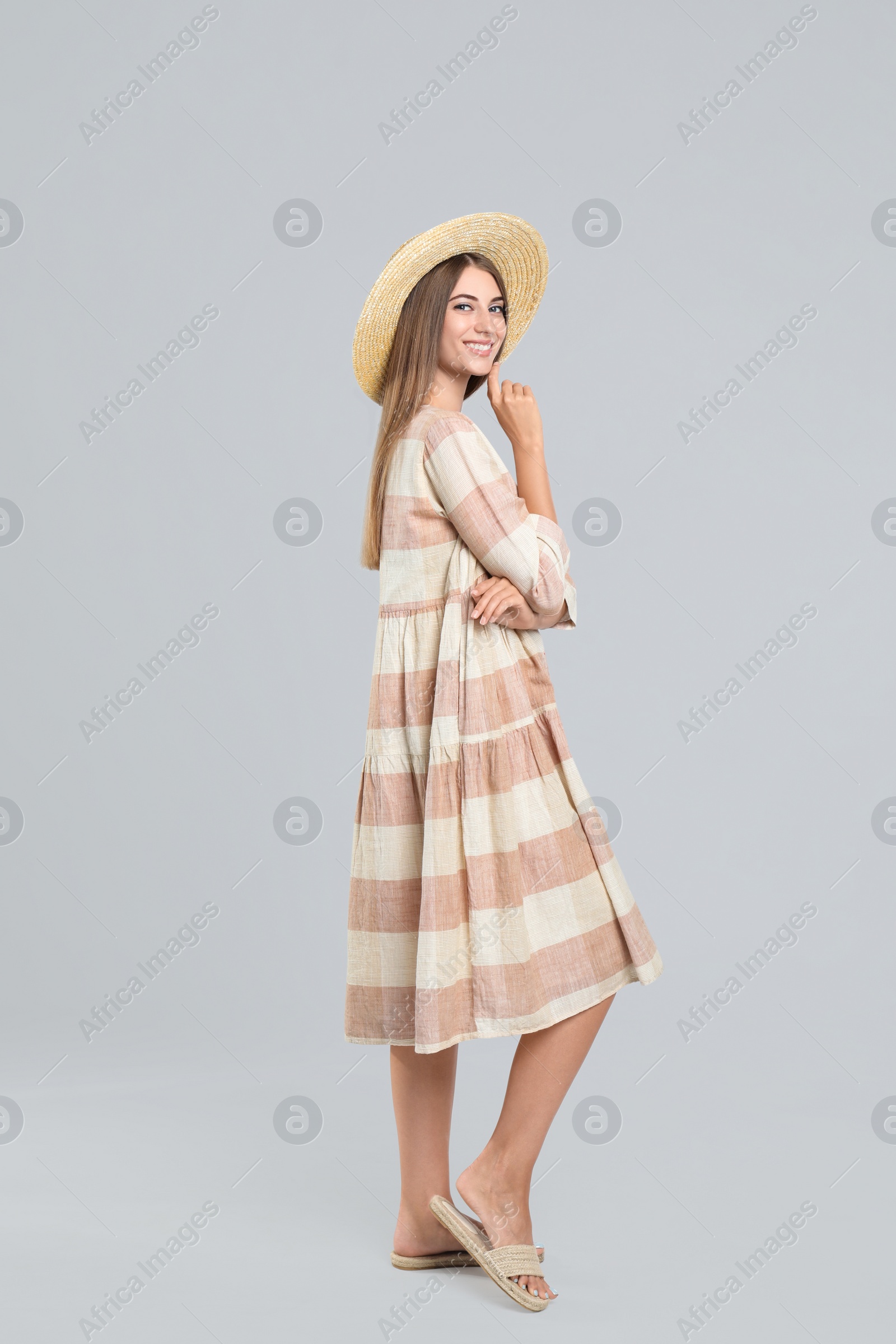 Photo of Young woman wearing stylish dress on light grey background