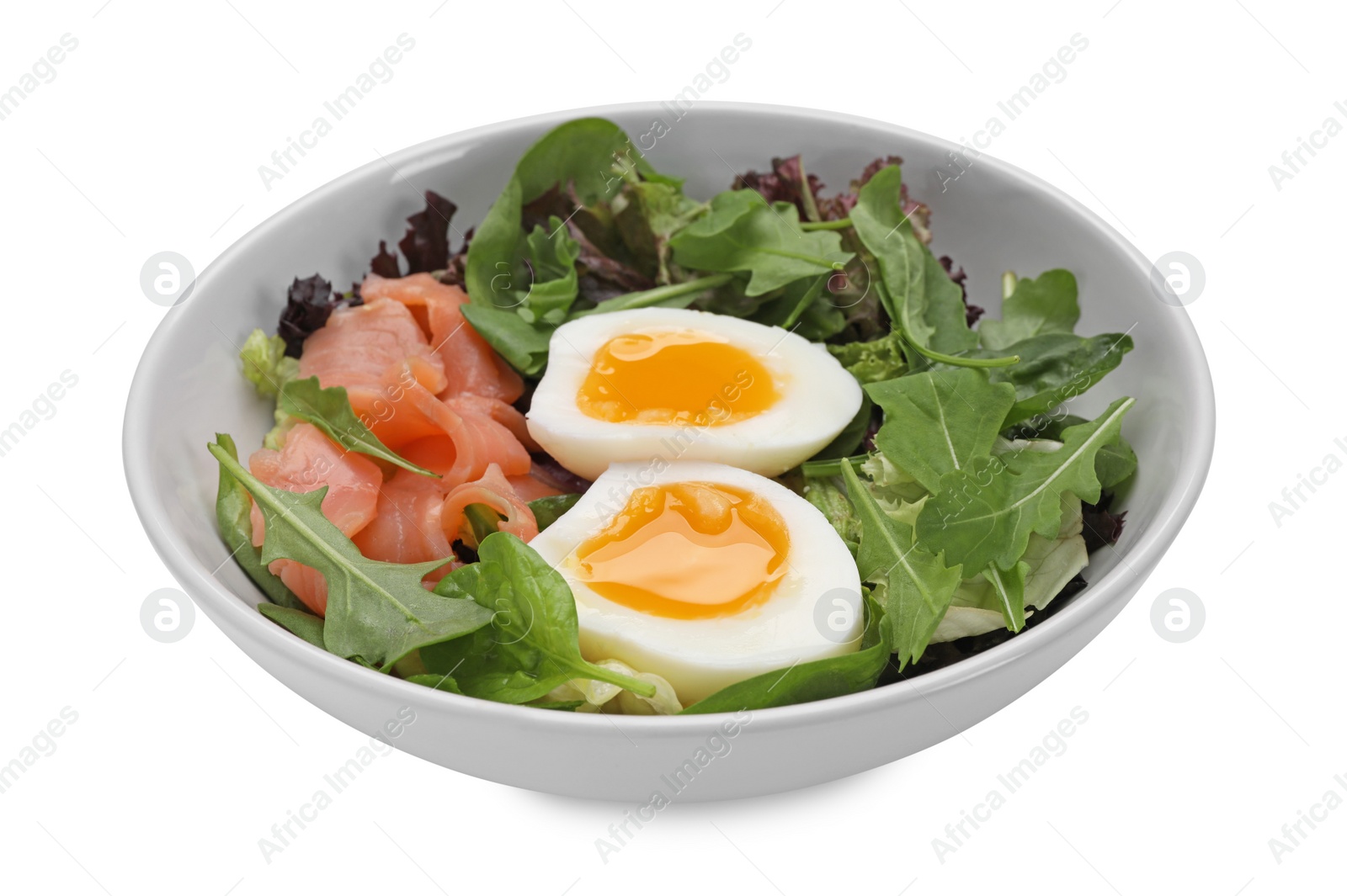 Photo of Delicious salad with boiled egg, salmon and arugula in bowl isolated on white