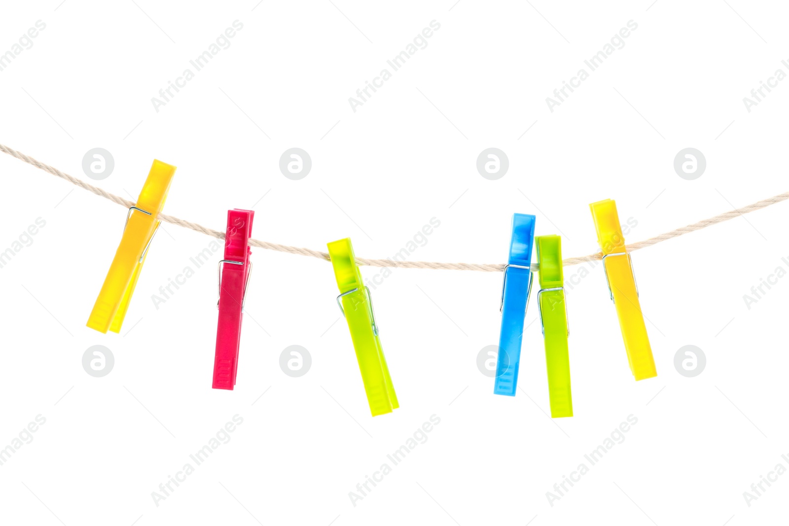 Photo of Colorful plastic clothespins hanging on rope against white background