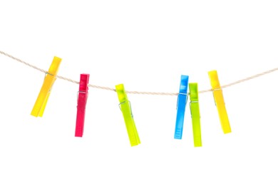 Colorful plastic clothespins hanging on rope against white background