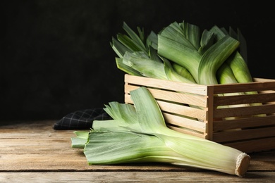 Fresh raw leeks on wooden table. Ripe onion