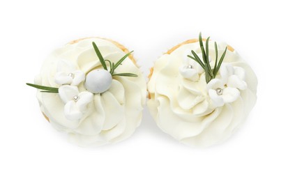 Photo of Tasty Easter cupcakes with vanilla cream isolated on white, top view