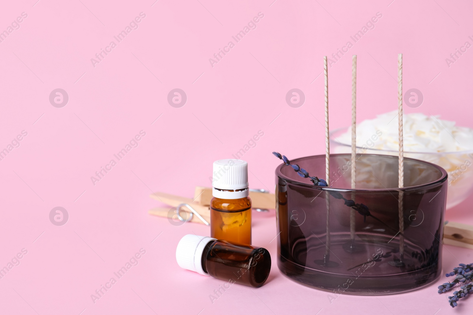 Photo of Composition with homemade candle ingredients on pink background, space for text