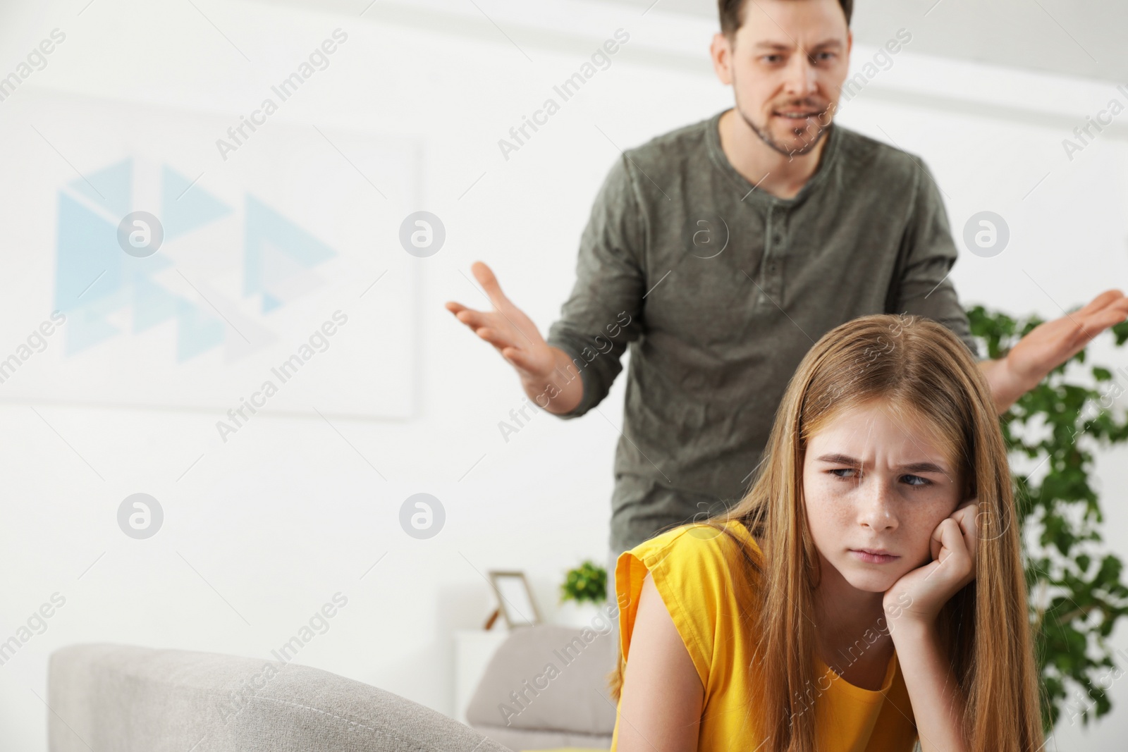 Photo of Father scolding his teenager daughter at home