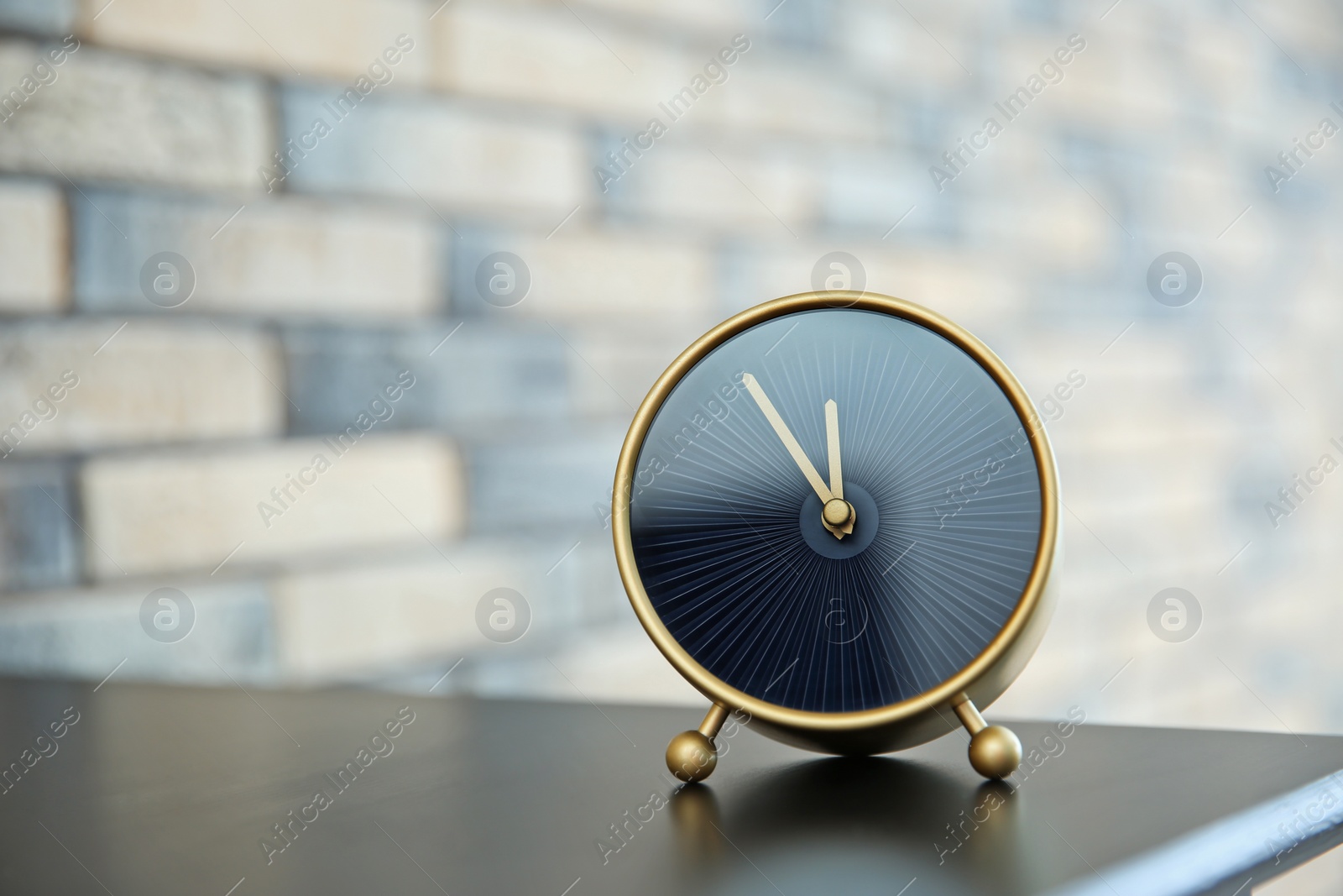 Photo of Alarm clock on table indoors. Time concept