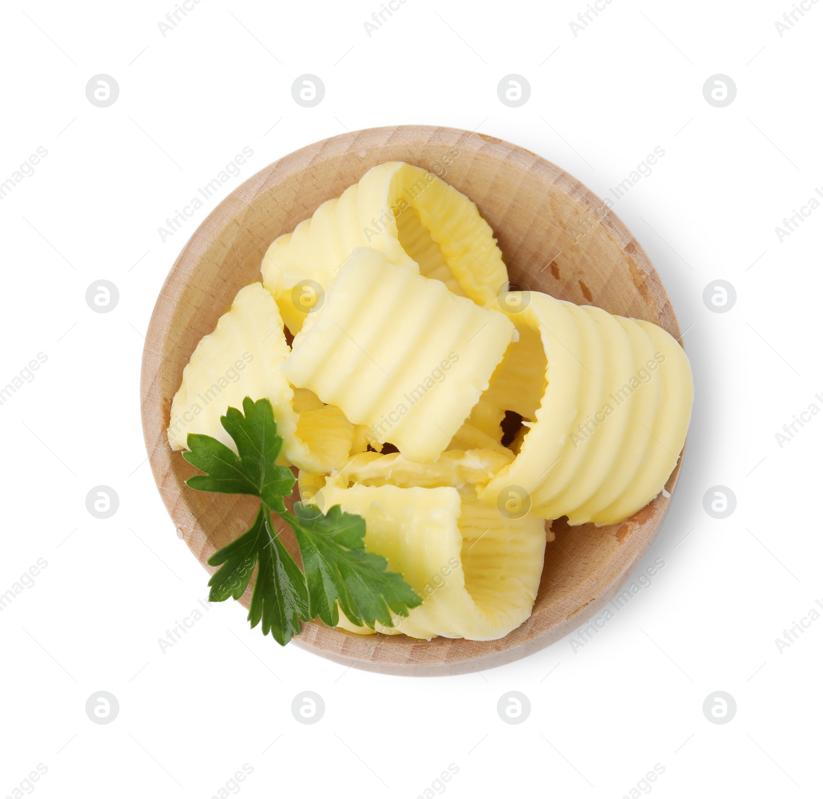Photo of Tasty butter curls and fresh parsley in bowl isolated on white, top view