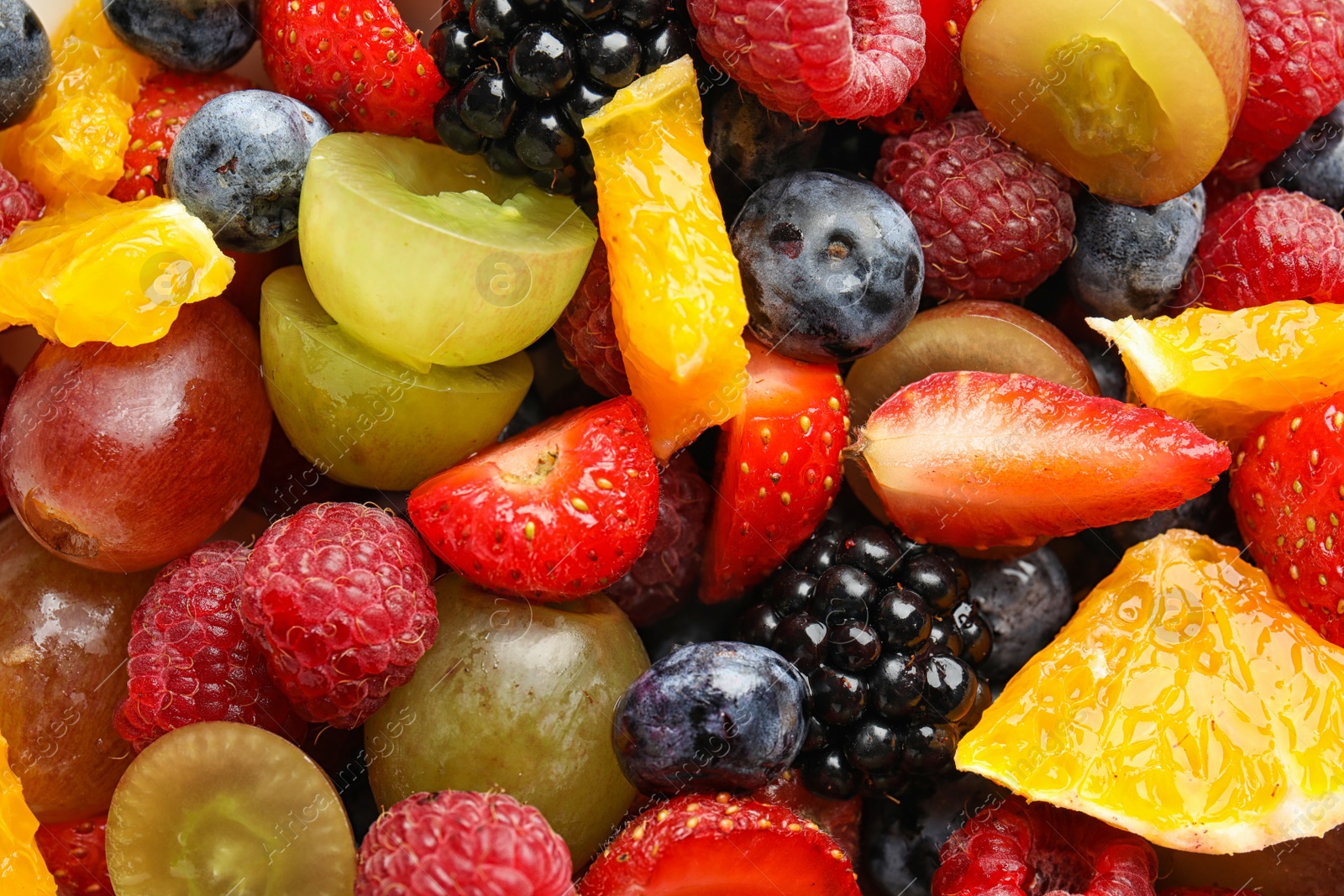 Photo of Fresh tasty fruit salad as background, top view