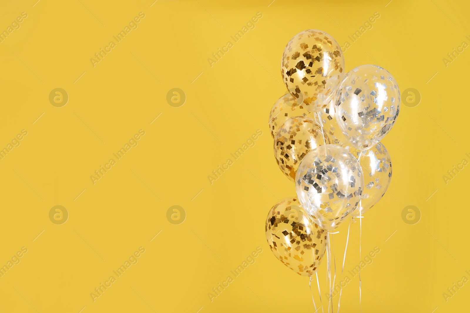 Photo of Bunch of bright balloons on color background. Space for text
