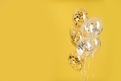 Photo of Bunch of bright balloons on color background. Space for text