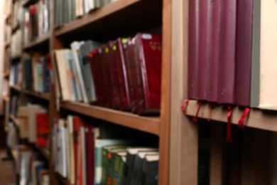 Blurred view of books on shelves in library