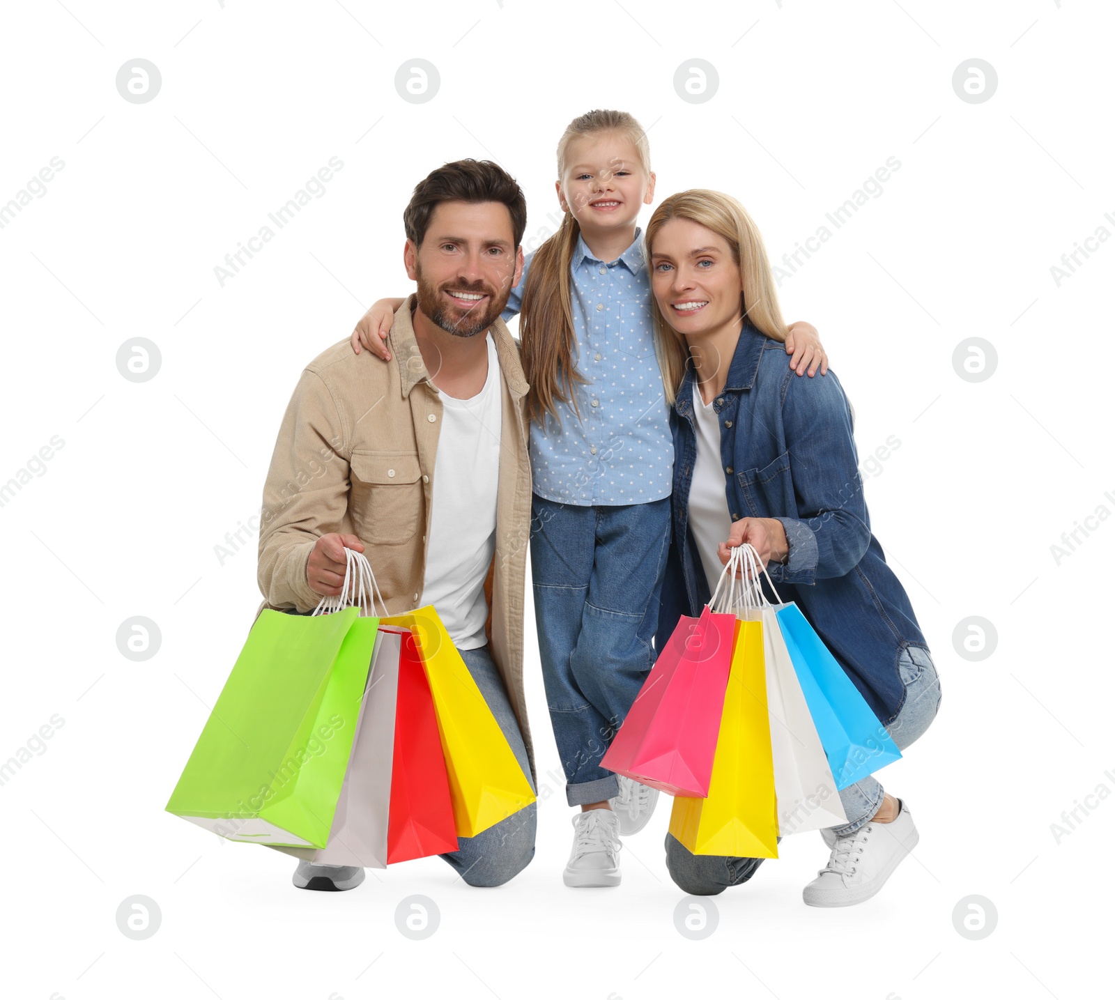 Photo of Family shopping. Happy parents and daughter with many colorful bags on white background