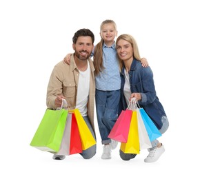 Family shopping. Happy parents and daughter with many colorful bags on white background