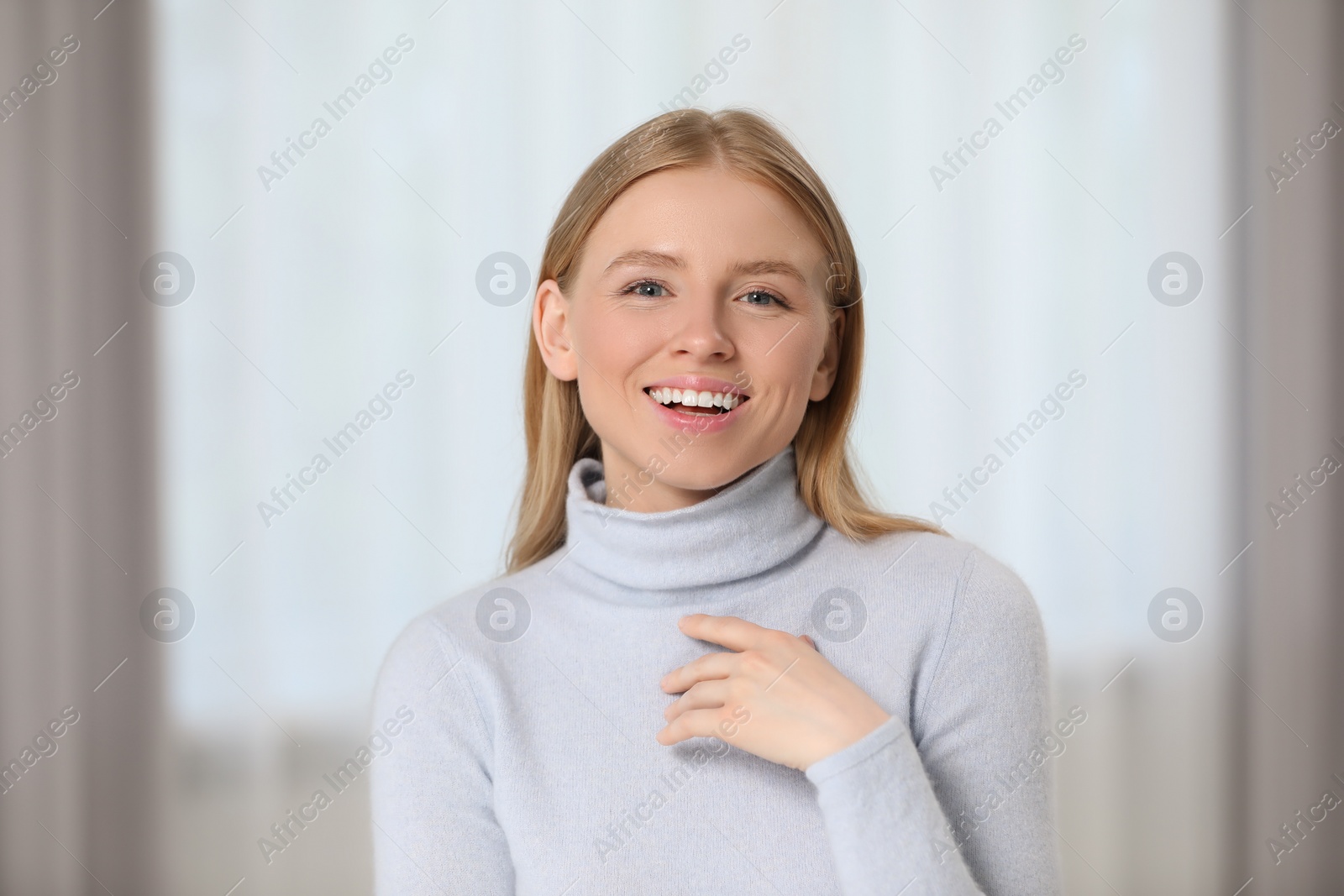 Photo of Portrait of beautiful young woman at home