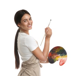 Young woman drawing with brush on white background